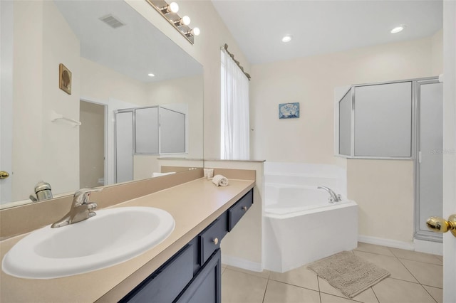 8622 La Isla Dr, Kissimmee, FL 34747 - full bath featuring vanity, a garden tub, tile patterned floors, a shower stall, and baseboards