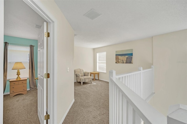 8622 La Isla Dr, Kissimmee, FL 34747 - corridor with light colored carpet, plenty of natural light, an upstairs landing, and a textured ceiling