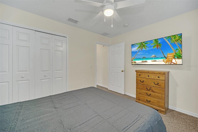 8622 La Isla Dr, Kissimmee, FL 34747 - carpeted bedroom with a closet, baseboards, a ceiling fan, and a textured ceiling