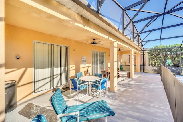 8622 La Isla Dr, Kissimmee, FL 34747 - view of patio featuring ceiling fan, outdoor dining space, and glass enclosure