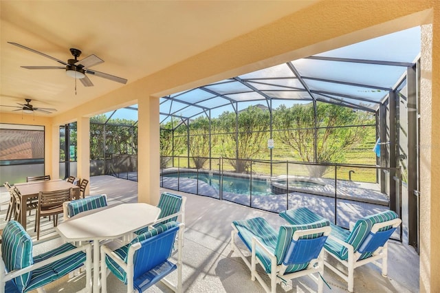 8622 La Isla Dr, Kissimmee, FL 34747 - view of patio / terrace featuring outdoor dining area, a ceiling fan, a pool with connected hot tub, and a lanai