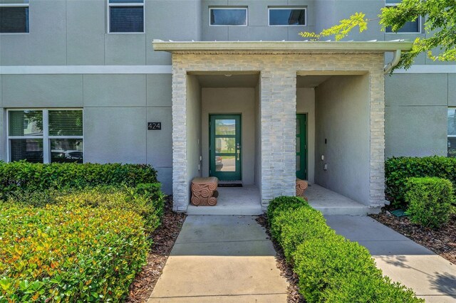 424 Ocean Course Ave, Davenport, FL 33896 - entrance to property featuring stucco siding and stone siding