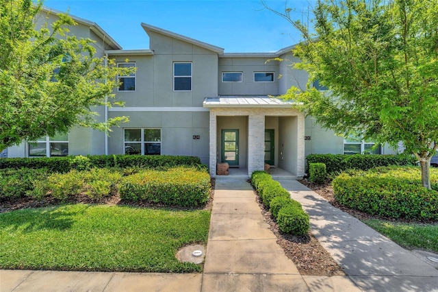 424 Ocean Course Ave, Davenport, FL 33896 - townhome / multi-family property with stucco siding, a standing seam roof, and a metal roof