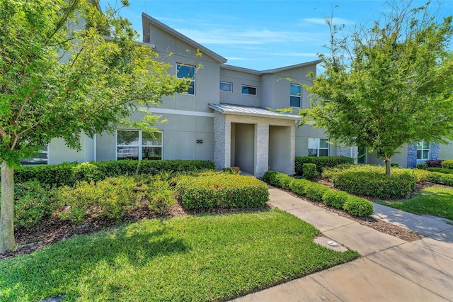 424 Ocean Course Ave, Davenport, FL 33896 - multi unit property with a standing seam roof, stucco siding, a metal roof, and a front lawn