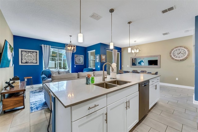 424 Ocean Course Ave, Davenport, FL 33896 - kitchen featuring a chandelier, dishwasher, open floor plan, an island with sink, and a textured ceiling