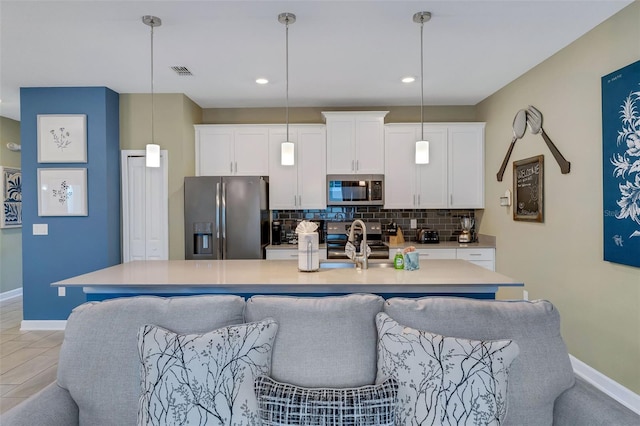 424 Ocean Course Ave, Davenport, FL 33896 - kitchen with stainless steel appliances, tasteful backsplash, white cabinets, light countertops, and recessed lighting