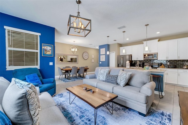 424 Ocean Course Ave, Davenport, FL 33896 - living room with a chandelier, light tile patterned floors, and recessed lighting