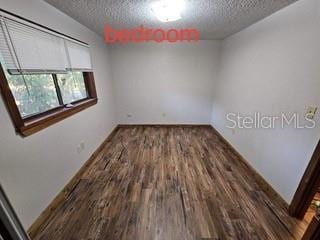 131 Stefanik Rd, Winter Park, FL 32792 - unfurnished room with a textured ceiling, wood finished floors, and baseboards