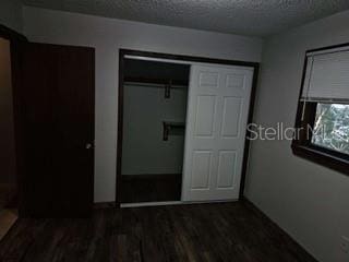 131 Stefanik Rd, Winter Park, FL 32792 - unfurnished bedroom featuring a textured ceiling, wood finished floors, and a closet