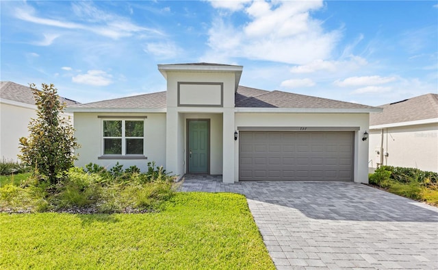 797 Lemon Ave, Fruitland Park, FL 34731 - view of front facade with an attached garage, stucco siding, decorative driveway, a shingled roof, and a front yard