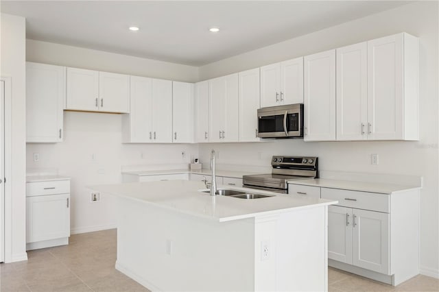 797 Lemon Ave, Fruitland Park, FL 34731 - kitchen featuring appliances with stainless steel finishes, a sink, a kitchen island with sink, light tile patterned flooring, and recessed lighting