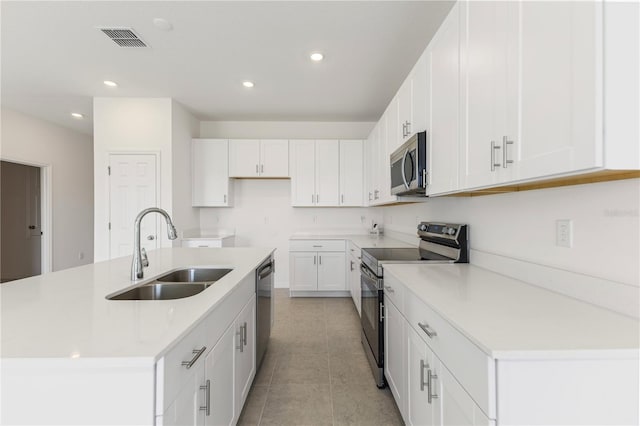 797 Lemon Ave, Fruitland Park, FL 34731 - kitchen featuring appliances with stainless steel finishes, a sink, recessed lighting, white cabinetry, and an island with sink