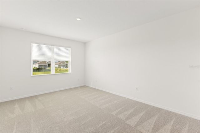797 Lemon Ave, Fruitland Park, FL 34731 - spare room featuring light colored carpet, baseboards, and recessed lighting