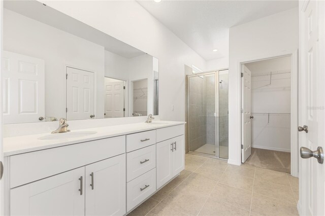 797 Lemon Ave, Fruitland Park, FL 34731 - full bath with a spacious closet, a shower stall, double vanity, tile patterned floors, and recessed lighting