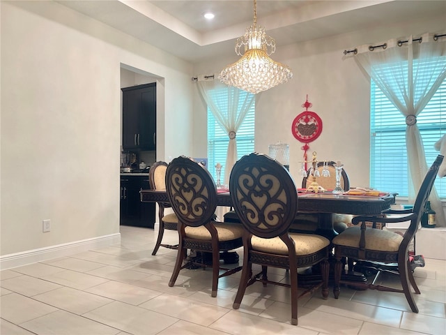 16611 Toccoa Row, Winter Garden, FL 34787 - dining area featuring a chandelier, light tile patterned floors, and a tray ceiling