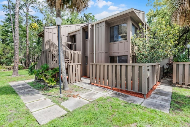 5301 Burning Tree Dr Unit F, Orlando, FL 32811 - view of front of house featuring board and batten siding