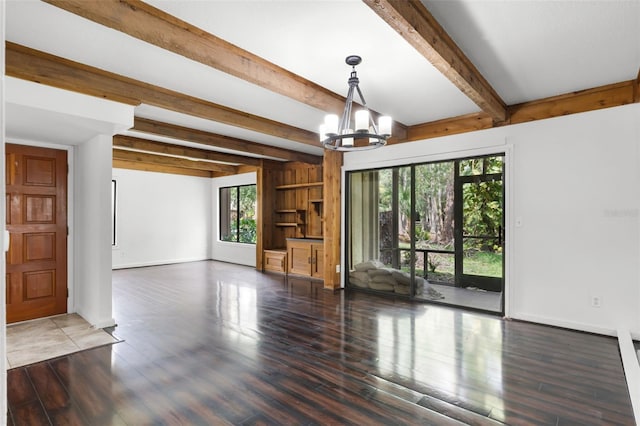 5301 Burning Tree Dr Unit F, Orlando, FL 32811 - unfurnished living room featuring healthy amount of natural light, a chandelier, beamed ceiling, and wood finished floors