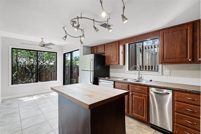 5301 Burning Tree Dr Unit F, Orlando, FL 32811 - kitchen with freestanding refrigerator, light tile patterned flooring, wooden counters, healthy amount of natural light, and a textured ceiling