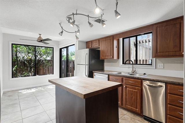 5301 Burning Tree Dr Unit F, Orlando, FL 32811 - kitchen with stainless steel appliances, butcher block counters, light tile patterned flooring, healthy amount of natural light, and a textured ceiling
