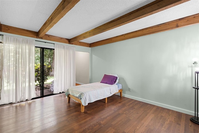 5301 Burning Tree Dr Unit F, Orlando, FL 32811 - bedroom featuring access to exterior, beamed ceiling, wood finished floors, and a textured ceiling