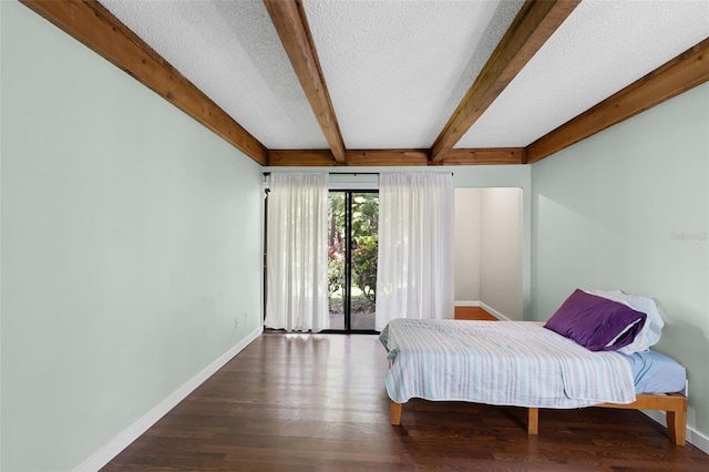 5301 Burning Tree Dr Unit F, Orlando, FL 32811 - bedroom with beamed ceiling, access to exterior, a textured ceiling, and wood finished floors