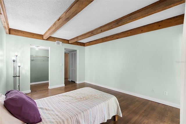 5301 Burning Tree Dr Unit F, Orlando, FL 32811 - bedroom featuring beam ceiling and wood finished floors