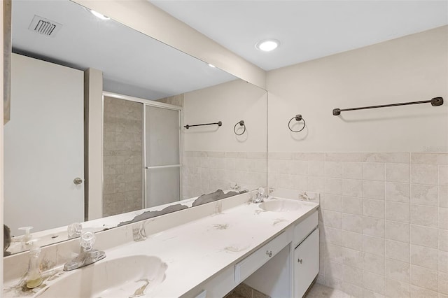 5301 Burning Tree Dr Unit F, Orlando, FL 32811 - full bath with tile walls, double vanity, a stall shower, and wainscoting