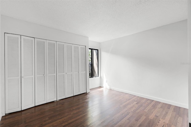 5301 Burning Tree Dr Unit F, Orlando, FL 32811 - unfurnished bedroom with wood finished floors, a textured ceiling, and a closet
