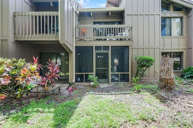 5301 Burning Tree Dr Unit F, Orlando, FL 32811 - back of house with a balcony, board and batten siding, and a sunroom