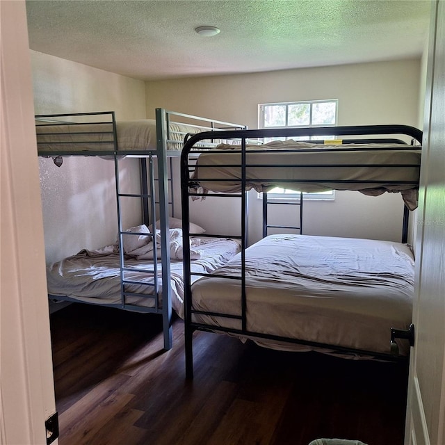 10012 Lake Louisa Rd, Clermont, FL 34711 - bedroom featuring wood finished floors and a textured ceiling