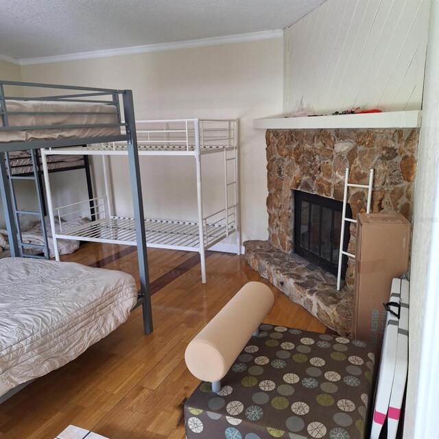 10012 Lake Louisa Rd, Clermont, FL 34711 - bedroom with wood finished floors, crown molding, and a fireplace