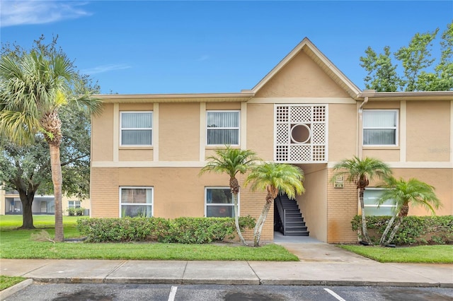9900 Sweepstakes Ln Unit 1, Orlando, FL 32837 - view of property featuring stairway and stucco siding