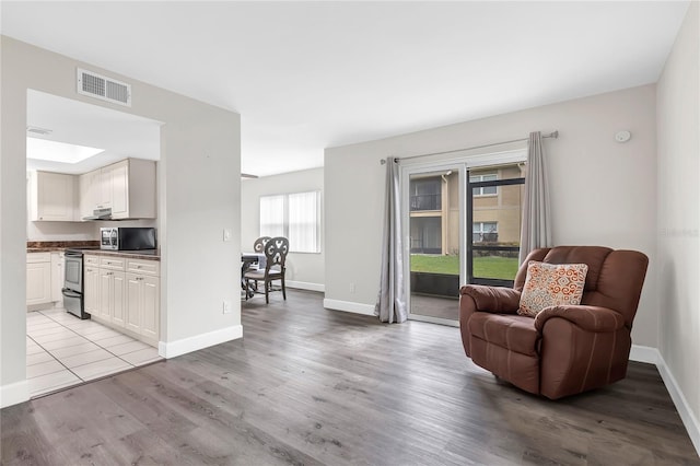 9900 Sweepstakes Ln Unit 1, Orlando, FL 32837 - sitting room with baseboards and light wood-style flooring