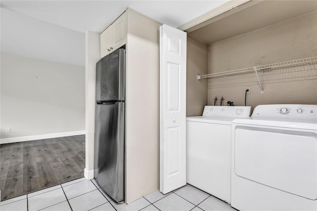 9900 Sweepstakes Ln Unit 1, Orlando, FL 32837 - washroom with washing machine and clothes dryer and light tile patterned flooring