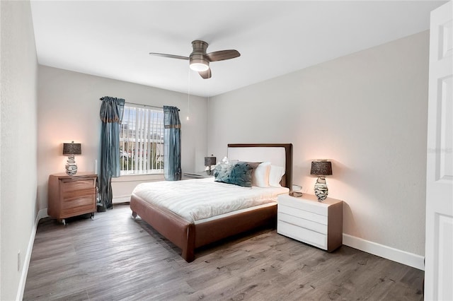 9900 Sweepstakes Ln Unit 1, Orlando, FL 32837 - bedroom with baseboards, wood finished floors, and a ceiling fan