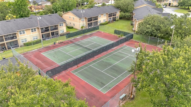 9900 Sweepstakes Ln Unit 1, Orlando, FL 32837 - view of tennis court with a residential view
