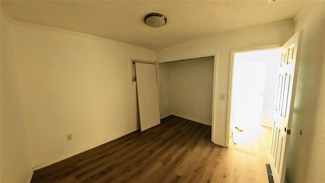 39 S College Ave, Maitland, FL 32751 - unfurnished bedroom with dark wood finished floors, a closet, and crown molding
