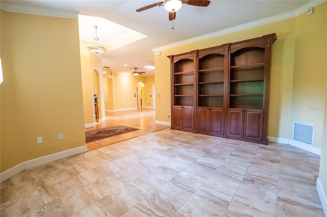 1550 Kevin Ln, Deland, FL 32724 - spare room featuring a ceiling fan, arched walkways, crown molding, and baseboards