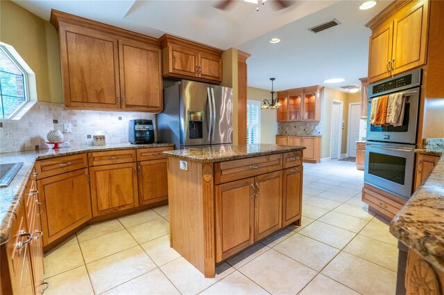 1550 Kevin Ln, Deland, FL 32724 - kitchen featuring appliances with stainless steel finishes, brown cabinetry, backsplash, a ceiling fan, and recessed lighting