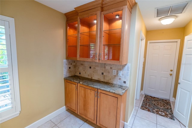 1550 Kevin Ln, Deland, FL 32724 - bar with decorative backsplash, light tile patterned floors, and baseboards