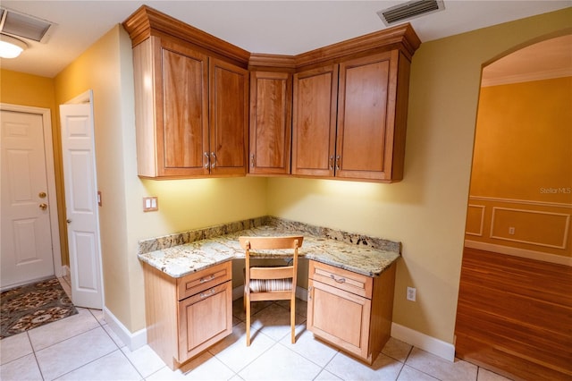 1550 Kevin Ln, Deland, FL 32724 - office space with built in desk, baseboards, arched walkways, and light tile patterned floors