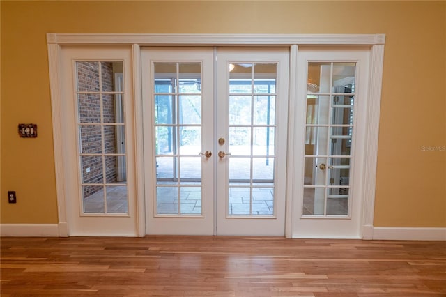 1550 Kevin Ln, Deland, FL 32724 - entryway with wood finished floors, baseboards, and french doors
