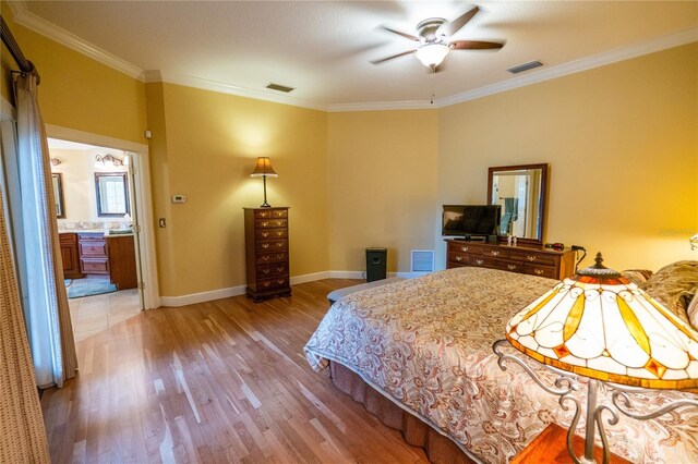 1550 Kevin Ln, Deland, FL 32724 - bedroom with light wood finished floors, ornamental molding, baseboards, and ensuite bath