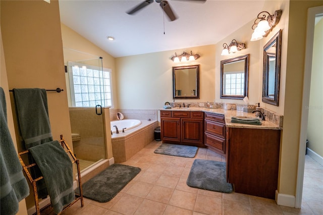 1550 Kevin Ln, Deland, FL 32724 - full bathroom with double vanity, a garden tub, a shower stall, ceiling fan, and tile patterned flooring
