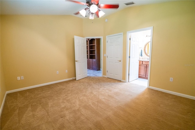 1550 Kevin Ln, Deland, FL 32724 - unfurnished bedroom with light carpet, vaulted ceiling, baseboards, and ensuite bathroom