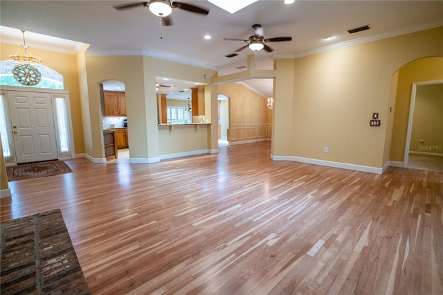 1550 Kevin Ln, Deland, FL 32724 - unfurnished living room with arched walkways, ceiling fan, ornamental molding, light wood-type flooring, and recessed lighting