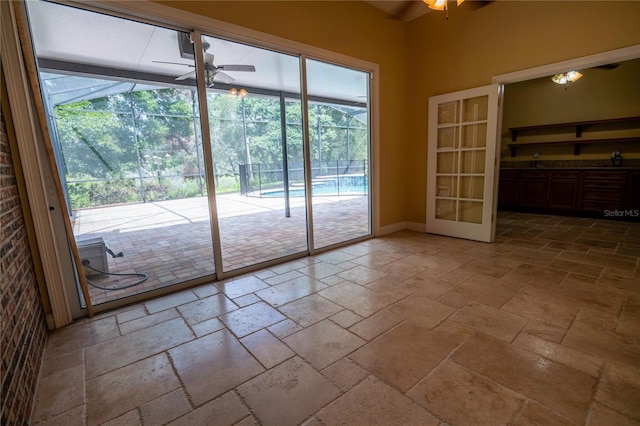 1550 Kevin Ln, Deland, FL 32724 - unfurnished dining area featuring a ceiling fan, stone tile flooring, healthy amount of natural light, and french doors