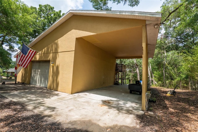 1550 Kevin Ln, Deland, FL 32724 - view of parking / parking lot featuring a garage, a carport, and concrete driveway