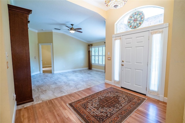 1550 Kevin Ln, Deland, FL 32724 - foyer with crown molding, light wood-style floors, a ceiling fan, vaulted ceiling, and baseboards