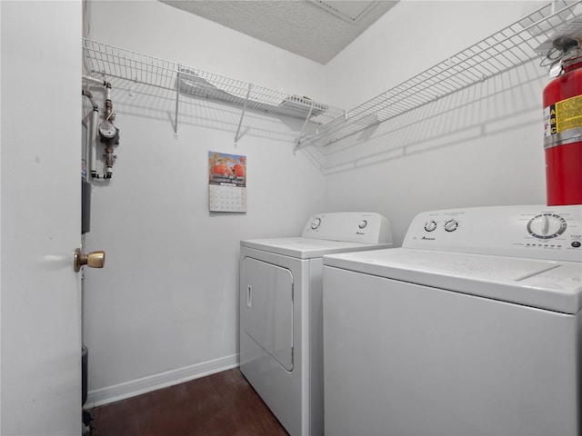 2533 Grassy Point Dr Unit 215, Lake Mary, FL 32746 - washroom featuring independent washer and dryer, dark wood finished floors, and baseboards